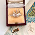 Vintage silver  Mayflower ship charm in a jewelry box with a vintage card in the background