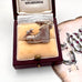 Vintage silver boot and mice charm on a jewellery box and with an old postcard in the background