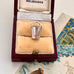 Vintage silver bucket charm in a jewelry box with 'Melbourne' branding.
