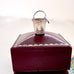 Vintage silver bucket charm on a jewelry box.