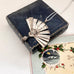 Vintage silver fan necklace on a vintage jewellery box and a vintage Christmas card.