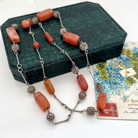 Vintage Middle eastern silver and carnelian chain necklace on a textured green box