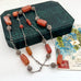 Vintage Middle eastern silver and carnelian chain necklace on a textured green box
