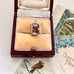 Vintage silver fridge charm in a jewelry box with vintage card in the background