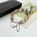 Vintage silver  bar gate bracelet with a heart-shaped padlock charm with an old box and vintage postcard