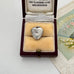 Heart-shaped silver locket pendant in a vintage jewellery box