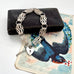 Silver bracelet with a heart-shaped lock charm on an antique card with a bird illustration.