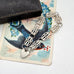 Silver bracelet with heart charm on a vintage card with birds and flowers