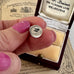 Silver  Leaning Tower Of Pisa charm in an open jewelry box with vintage paper in the background