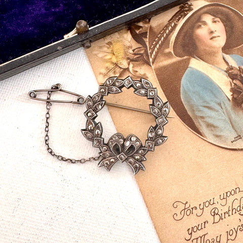 Decorative brooch on an old photograph with text