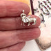 Vintage silver bullfighter charm in a woman's fingers