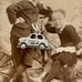 Vintage silver mini charm on an antique photo of children