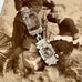 Vintage silver mini charm on an antique photo of children