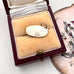 Vintage silver Parthenon charm in a jewelry box with a white background