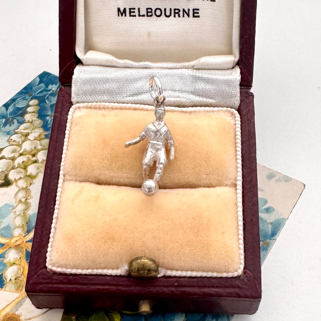 Silver soccer player charm in a Melbourne jewelry box