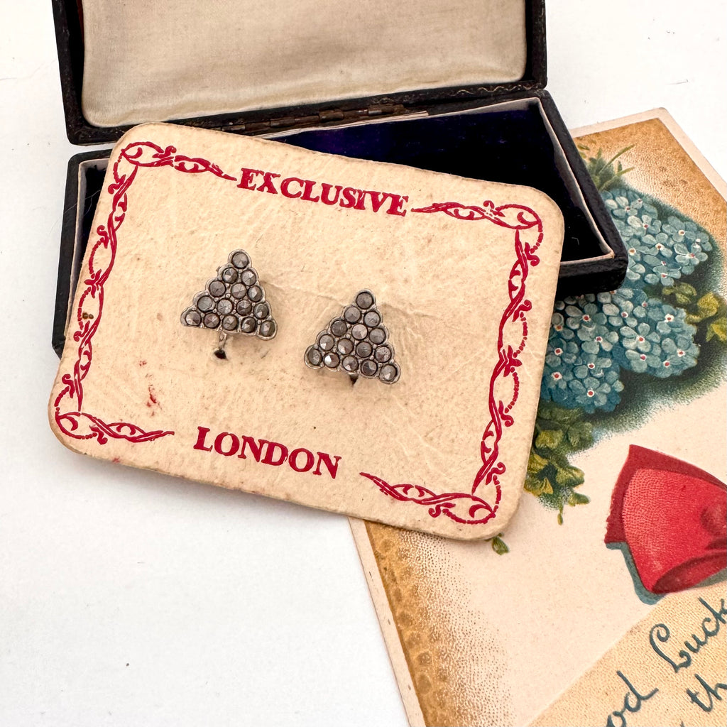 Pair of triangle-shaped earrings on a 'London' branded card with decorative border.
