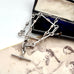Vintage trombone silver chain necklace on an old photograph with a vintage box in the background