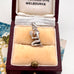 Vintage silver Virgo kneeling woman charm in a jewelry box with 'Flinders Lane Melbourne' branding.