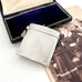 Vintage 1935 hallmarked vesta case made by G&SC Ltd of Regent St, London with a black box and vintage photo of children on a white background