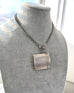 Vintage 1935 hallmarked vesta case made by G&SC Ltd of Regent St, London n an antique watch chain and on a grey mannequin