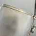 Close-up of a silver vesta case made by G&S C Ltd with engraved text on a gray background