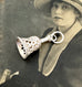 Vintage sterling silver bell charm on an antique photo of a woman