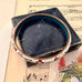 Vintage cloisonne bangle with floral design on a music sheet background