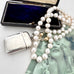 Vonk Jewellery 1889 sterling silver vesta case and pearls on a vintage postcard and with a vintage jewellery box