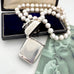 Vonk Jewellery 1889 sterling silver vesta case and pearls on a vintage postcard and with a vintage jewellery box