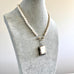 Vonk Jewellery 1889 sterling silver vesta case and pearls on a pale grey velvet jewellery display neck