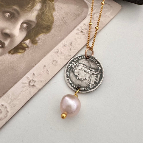 Vonk Jewellery antique silver threepence and pearl necklace with a vintage postcard