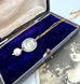 Vonk Jewellery antique silver threepence and pearl necklace with a vintage postcard and on a vintage jewellery box