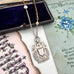 Vonk Jewellery 1898 sterling silver watch fob necklace with a vintage postcard and jewellery box