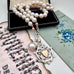 Vonk Jewellery 1900 watch fob and pearl necklace with a vintage postcard and jewellery box