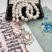 Vonk Jewellery 1900 watch fob and pearl necklace with a vintage postcard and jewellery box