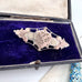 Vonk Jewellery 1905 antique sterling silver and rose gold sweetheart brooch on a vintage postcard and jewellery box