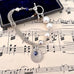 Vonk Jewellery 1905 threepence, pearl and sterling silver bracelet on a music manuscript and a vintage jewellery box