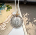 Vonk Jewellery 1911 British sixpence and pearl charm necklace on some vintage postcards