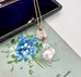 Vonk Jewellery 1915 silver threepence and baroque pearl necklace on a vintage jewellery box and vintage postcard