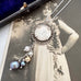 Vonk Jewellery 1918 silver threepence and pearl drop necklace on a vintage postcard and vintage jewellery box