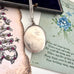 Vonk Jewellery 1876 sterling silver locket necklace on a vintage postcard and vintage jewellery box