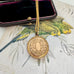 Vonk Jewellery antique R B M rolled gold locket on a vintage jewellery box and vintage postcard of love birds