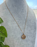 Vonk Jewellery antique R B M rolled gold locket on a grey jewellery display neck