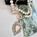 Vonk Jewellery antique watch fob pearl long necklace on a vintage postcard