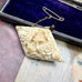 Vonk Jewellery antique bone brooch on a vintage jewellery box and postcard