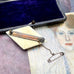 Vonk Jewellery antique bone brooch on a vintage jewellery box and postcard