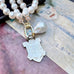 Vonk Jewellery Fattorini watch fob and pearl necklace on a purple background and with a vintage jewellery box