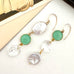 Vonk Jewellery aqua quartz, vintage crystal and large keshi pearl gold earrings on a white background and with a vintage postcard and box in the background
