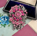 Vonk Jewellery large vintage marcasite and pink rhinestone brooch on a vintage postcard and with a vintage jewellery box