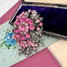 Vonk Jewellery large vintage marcasite and pink rhinestone brooch on a vintage postcard and with a vintage jewellery box
